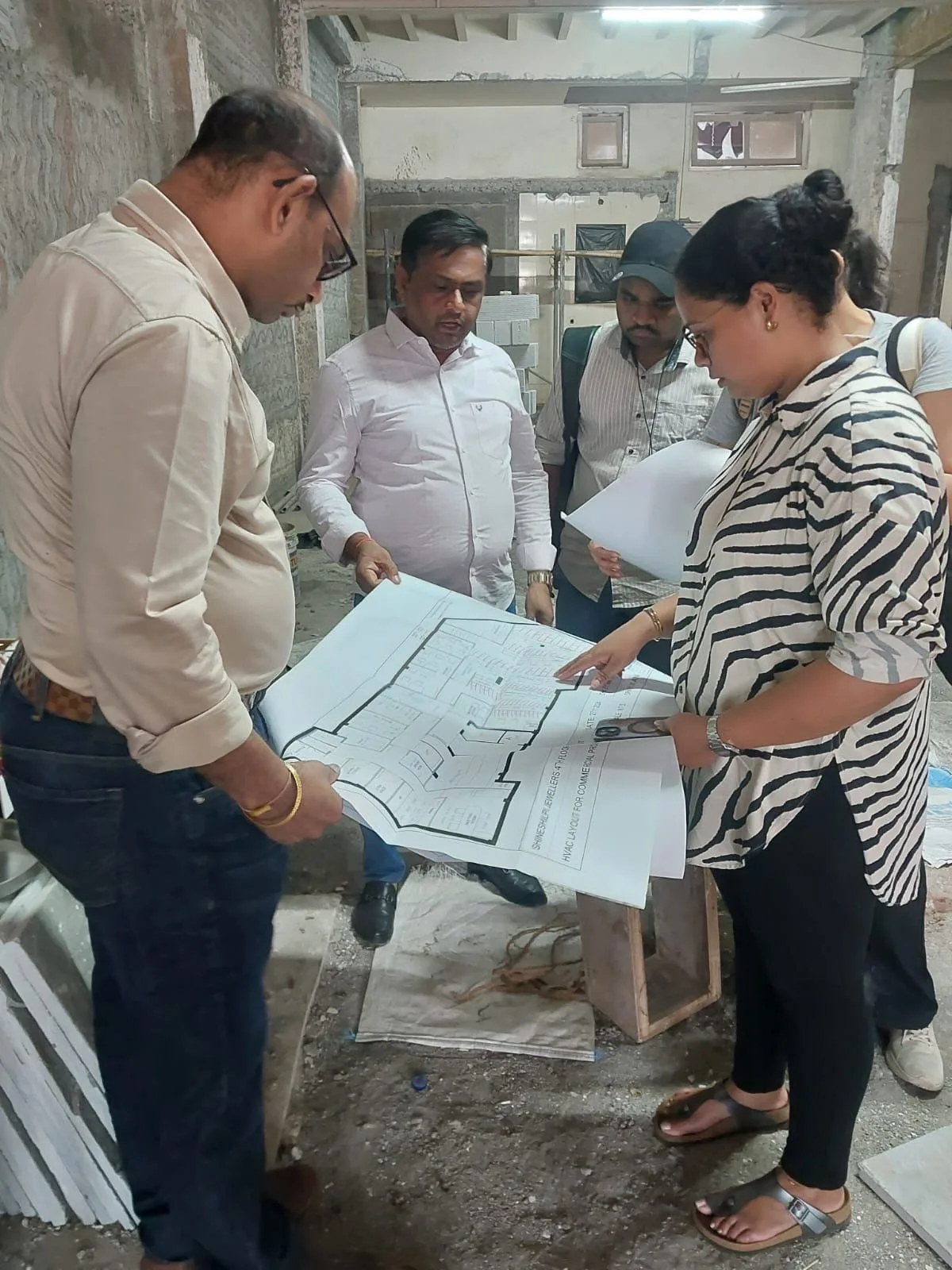 Bonanza Infra team reviewing blueprints on site